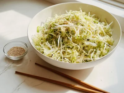 Bowl of Japanese cabbage salad with fresh vegetables and dressing
