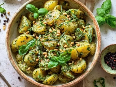 Delicious pesto potato salad served in a bowl with fresh ingredients