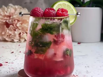 Finished Raspberry Lime Mojito Mocktail garnished with lime and raspberries