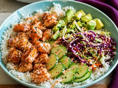 Delicious Salmon Rice Bowls featuring teriyaki salmon over fluffy rice and fresh veggies.