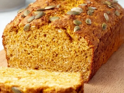 Freshly baked vegan chickpea bread on a wooden cutting board.