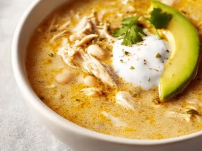 Bowl of hearty White Chicken Chili topped with cilantro and lime.