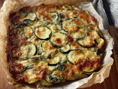 Low-calorie zucchini and spinach pie served in a rustic dish